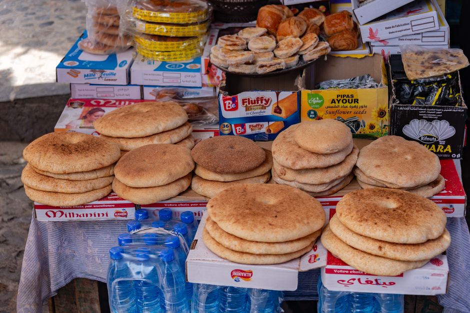 A variety of traditional flatbreads displayed in a local market setting.