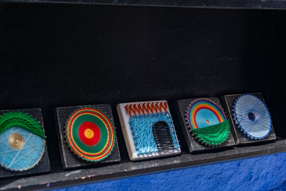 Close-up view of colorful handmade string art designs on display, showcasing vibrant patterns. Close-up view of colorful handmade string art designs on display, showcasing vibrant patterns.