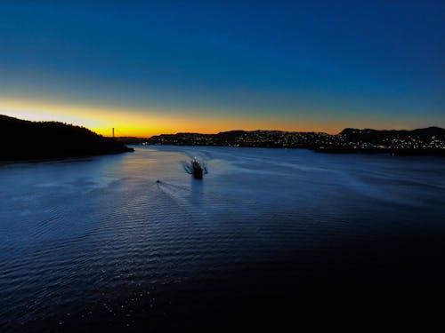 Black Ship Passing Channel at Night