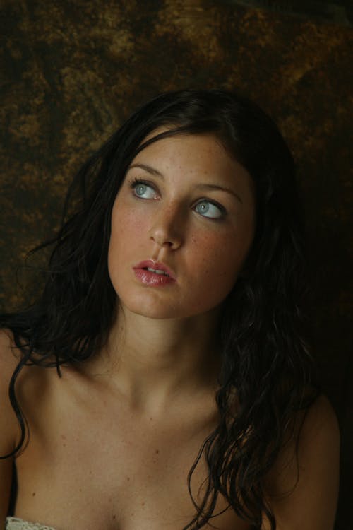 Portrait Photo of Woman Posing While Looking Up