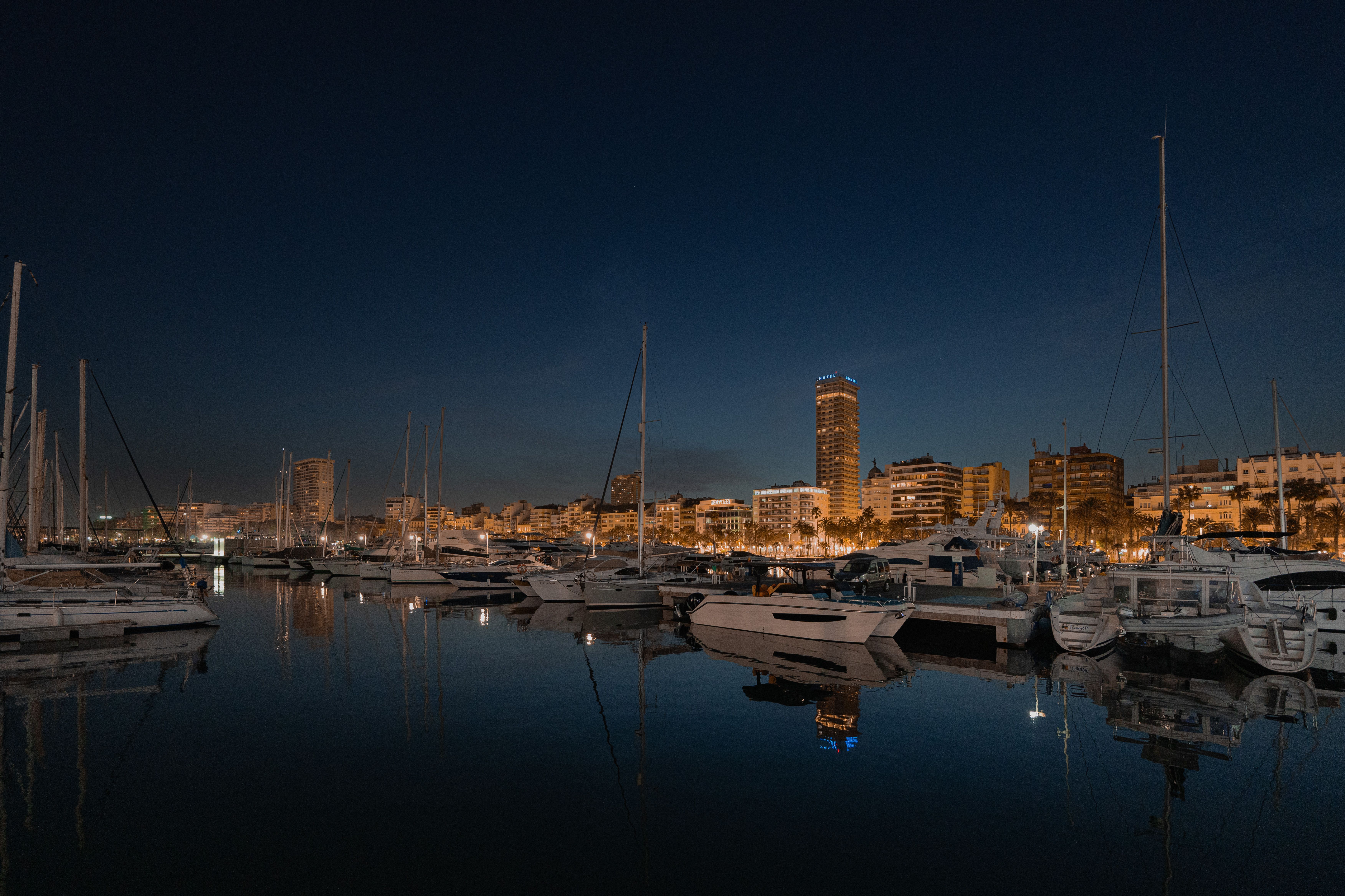 Spectacular Sunset Sailing Yacht Experience Small Group Review: Gran Canaria's Golden Hour Magic Review 2026 - Tranquil night view of Alicante harbor with sailboats and city skyline reflections under the evening sky.