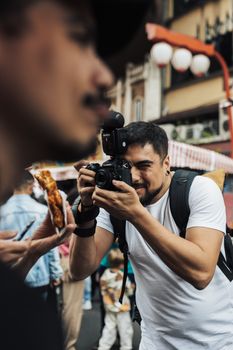 A street photographer captures vibrant moments at a bustling food festival.