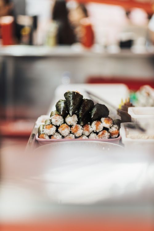 Free Fresh Japanese sushi rolls with nori and rice displayed at a restaurant. Stock Photo