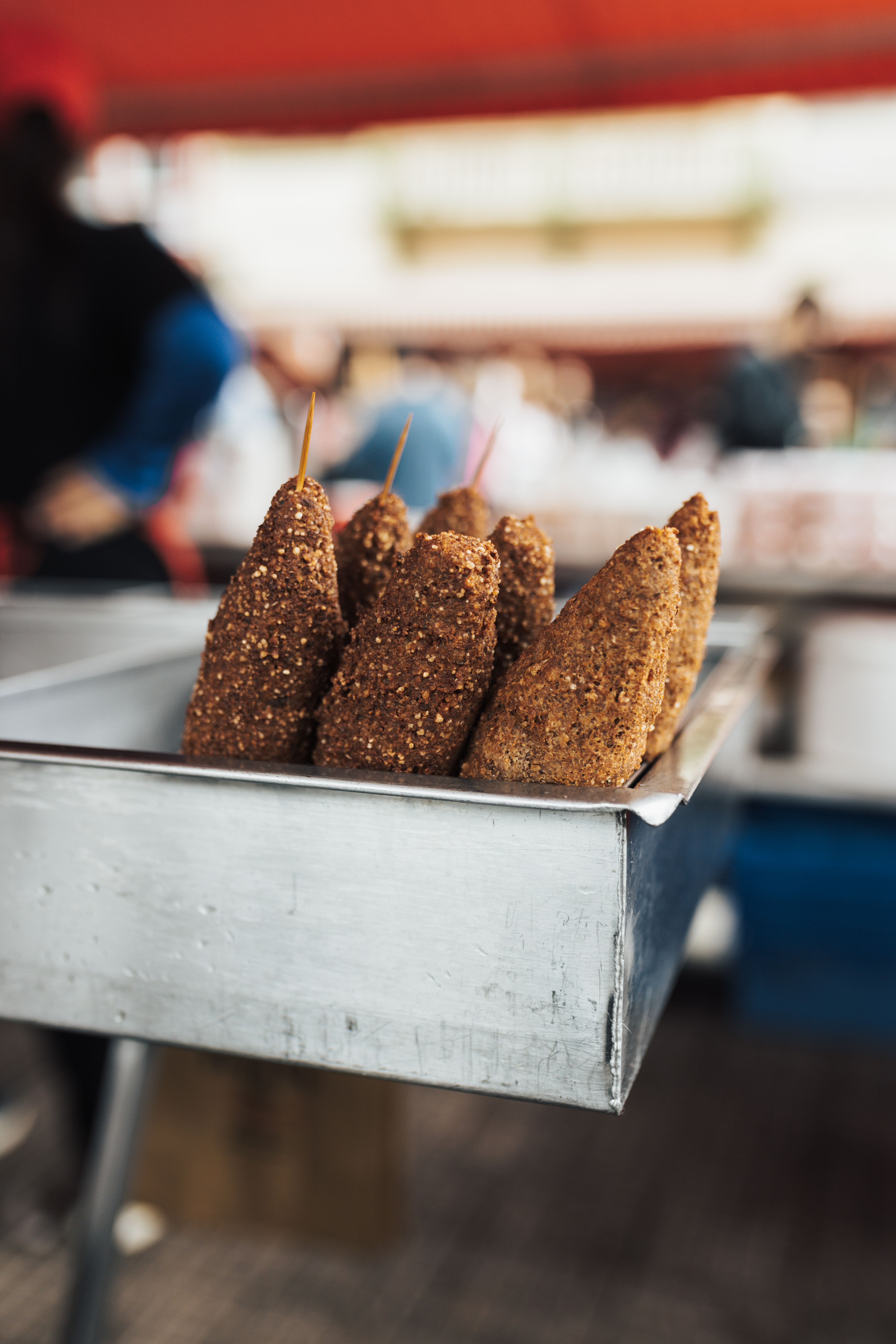 Savor the taste of these deep-fried skewers from a vibrant street food market, perfect for food enthusiasts.