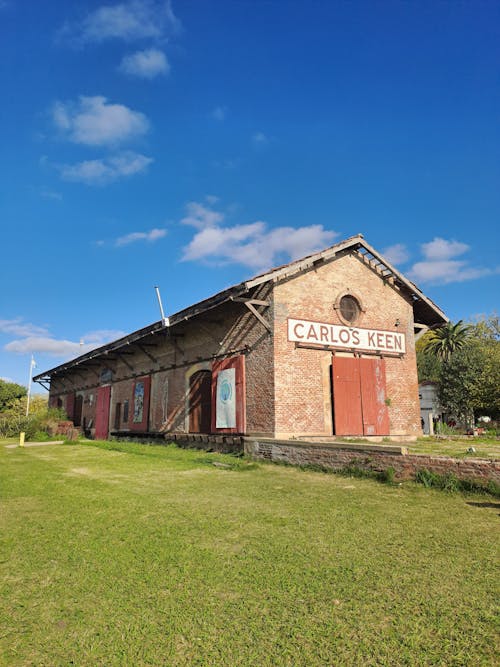 A large building with a red roof and a sign on it