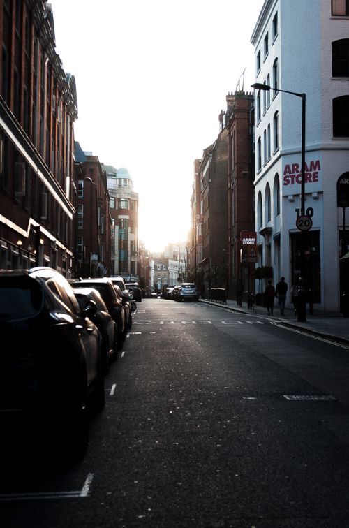 Free Capture of a London street at sunset featuring classic architecture and a serene urban setting. Stock Photo
