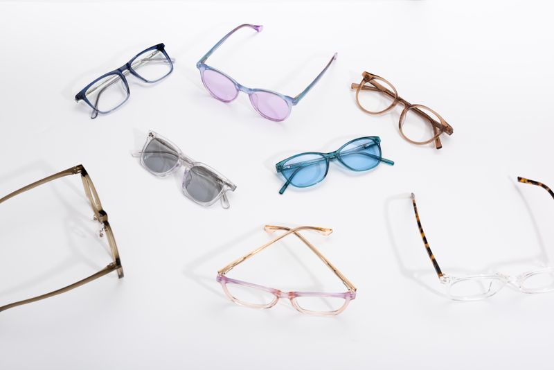 Assorted eyeglass frames on a white surface
