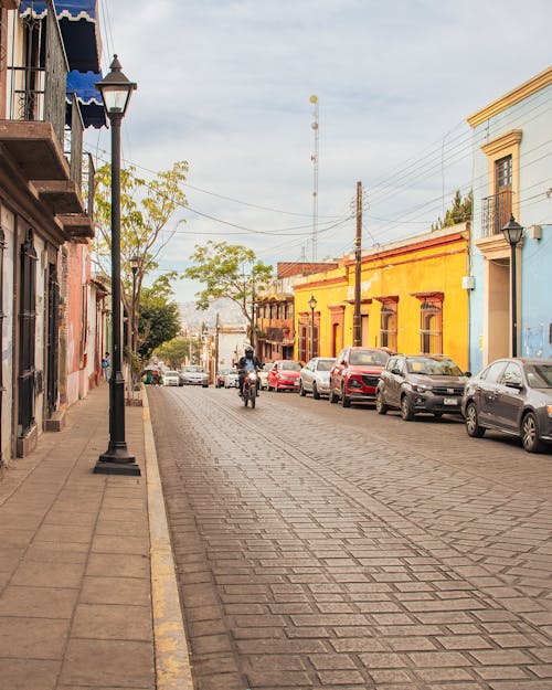 A person riding a bike down a street in a city