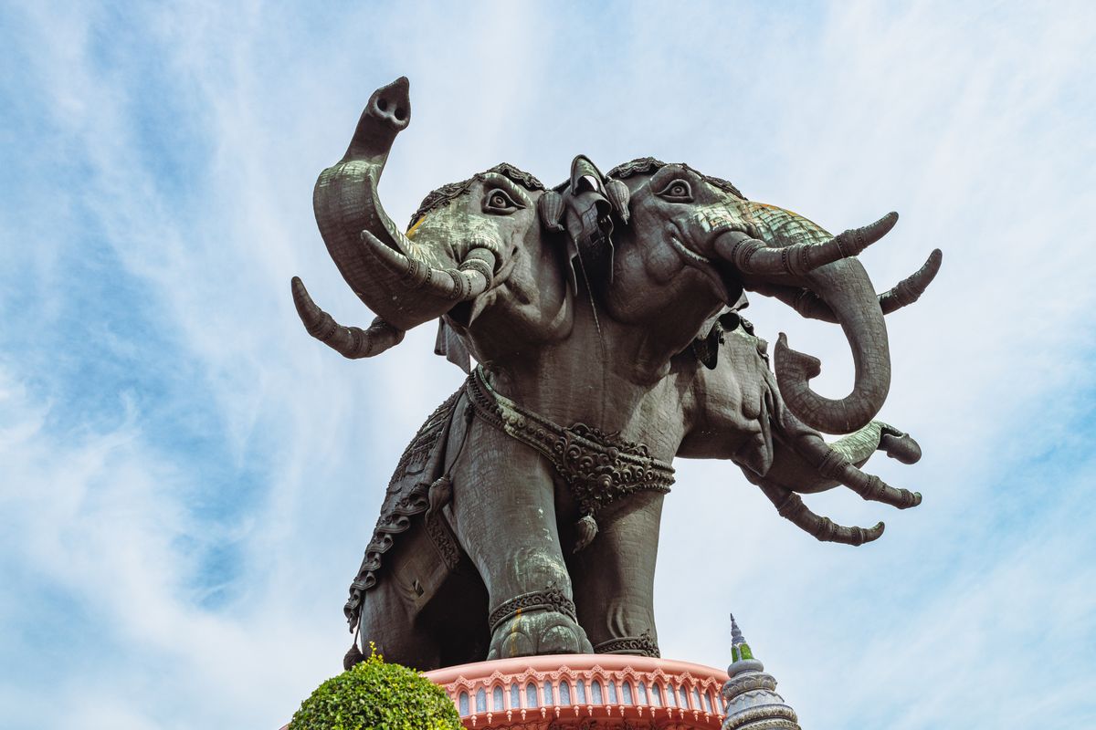 Majestic elephant statue at Erawan Museum in Bangkok, Thailand against a clear blue sky.