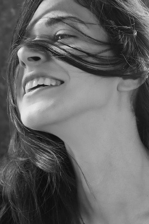 Grayscale Close-up Photo of Smiling Woman's Face