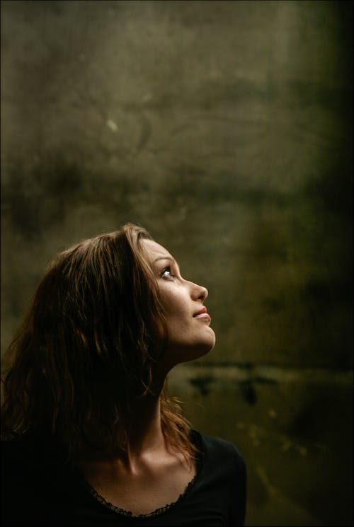 Side View Portrait Photo of Woman in Black Top Looking Up