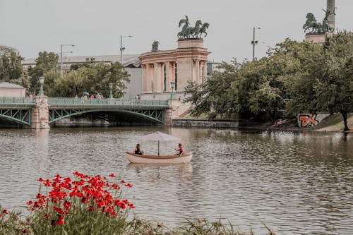 Two People On Boat At A River