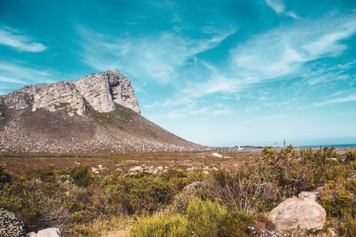Free Picturesque view of rough rocky terrain located near mountain under blue sky in summer day Stock Photo
