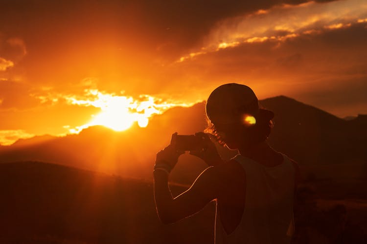 Photo Of Person Taking Picture Of Sunset