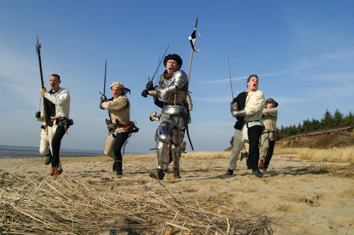 Photo of Men Holding Weapons