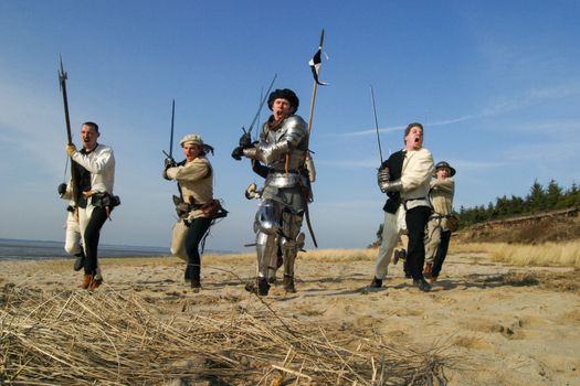 Photo of Men Holding Weapons