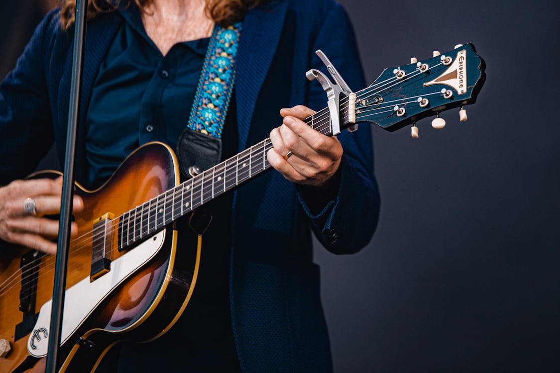 Free Shallow Focus Photo Of Person Playing Electric Guitar Stock Photo