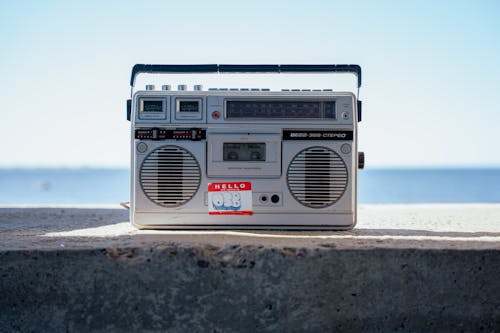 A boombox sitting on a concrete ledge next to the ocean