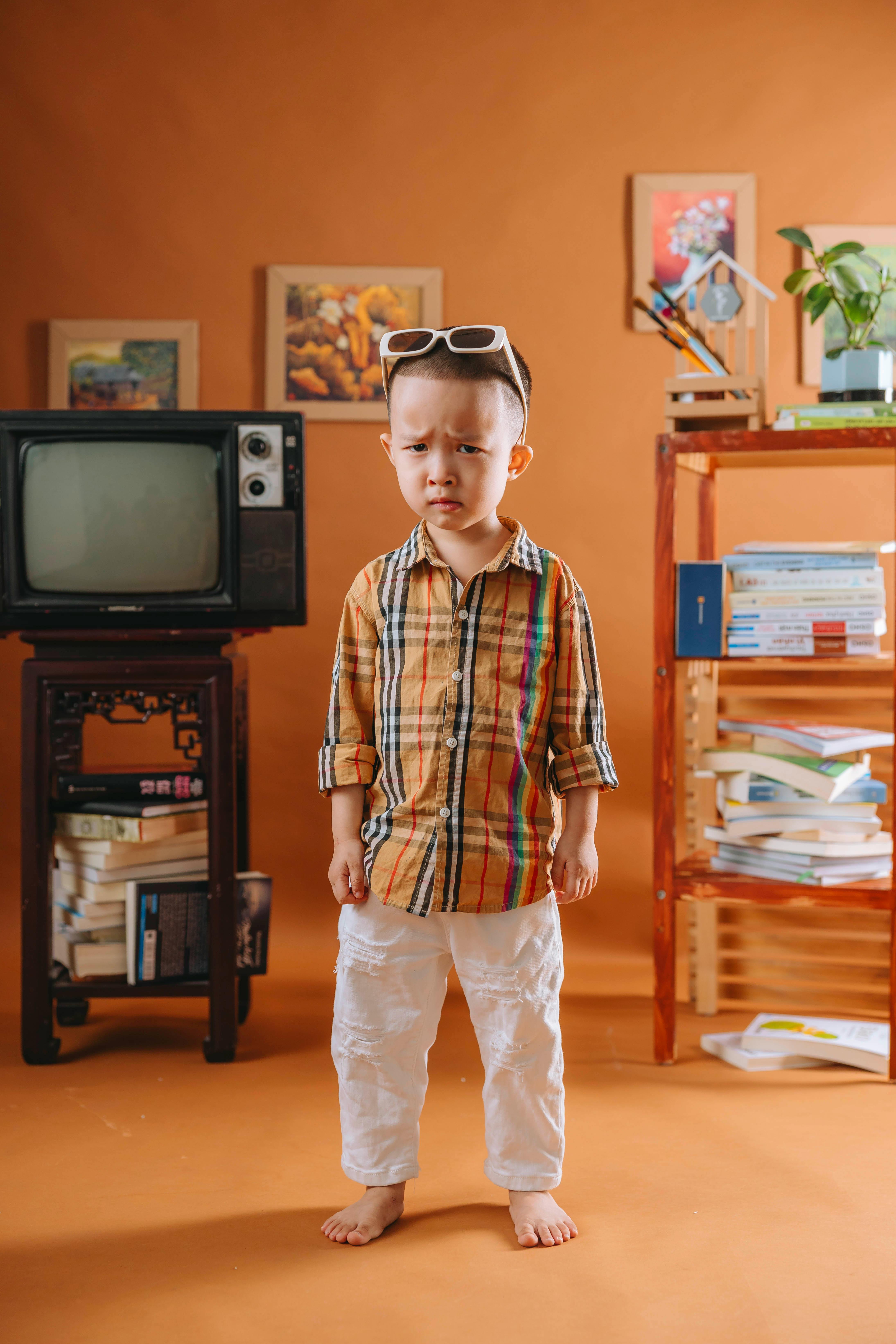 boy standing in an orange room