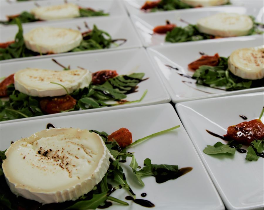 Rounds of white goat cheese on a plate