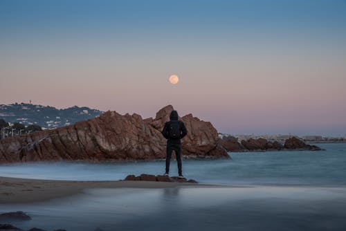 A Person Standing on the Beach Shore