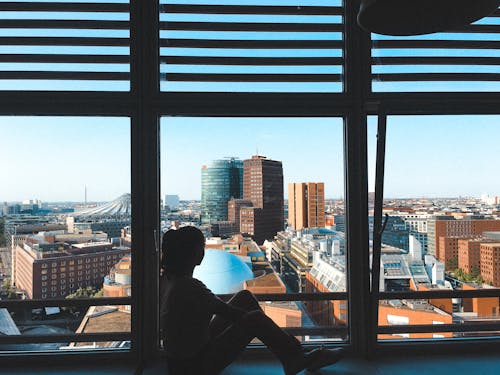 Photo of a Woman Looking Through Glass Wall