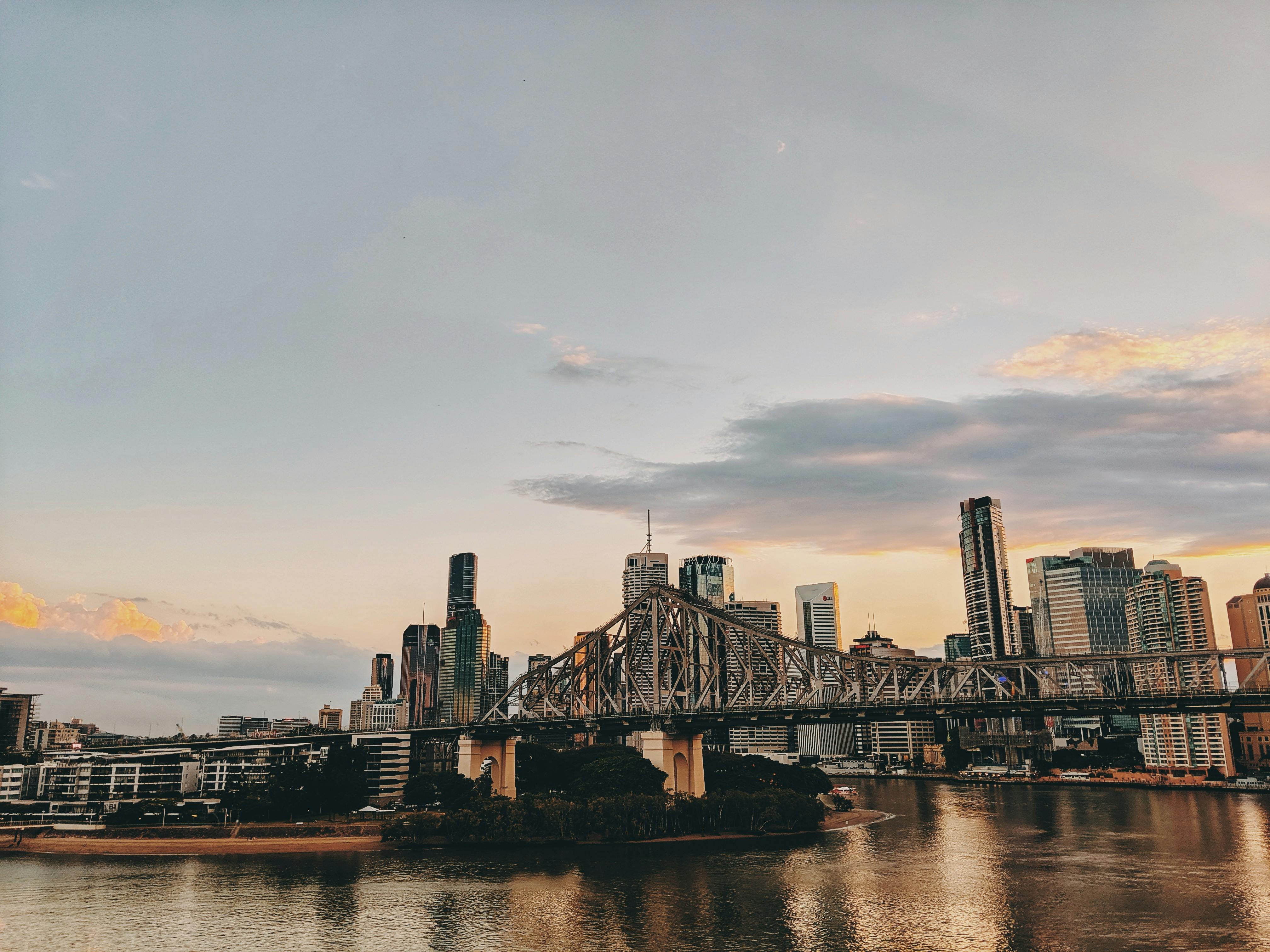 Photo Of Bridge And Buildings During Golden Hour · Free Stock Photo