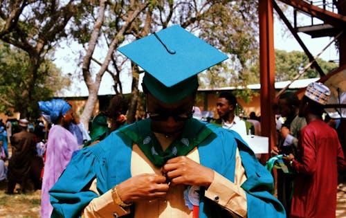 Photo of a Person Wearing Blue Academic Regalia