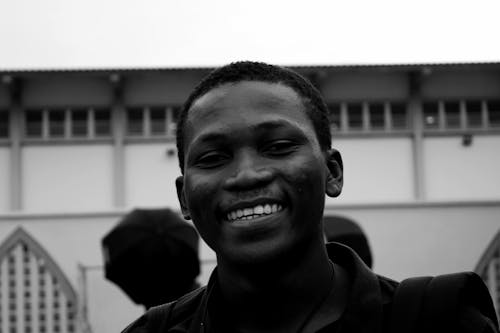 Grayscale Portrait Photo of Smiling Man