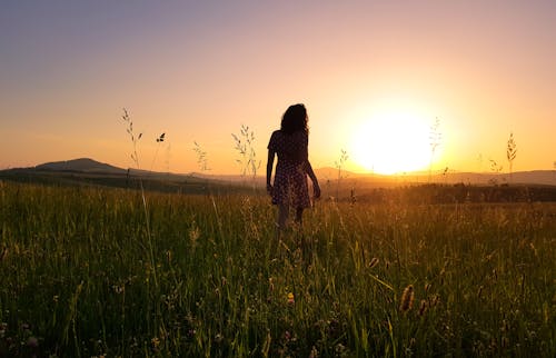 Woman Stainding on Green Field