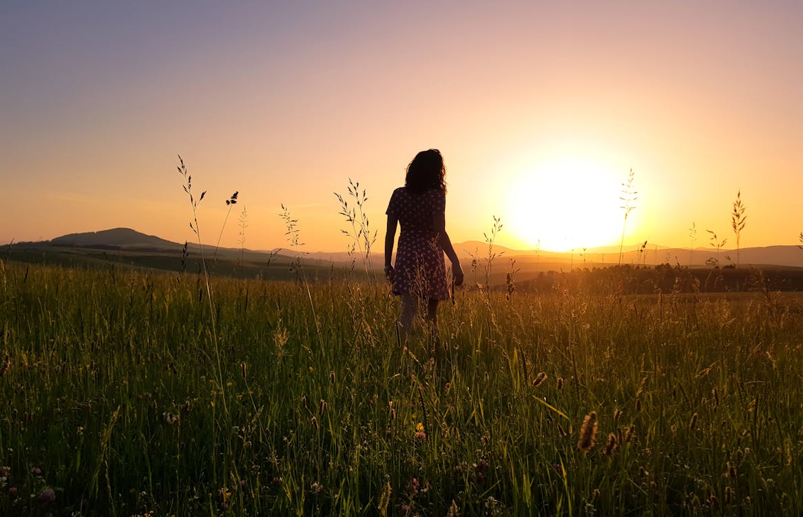 Free Woman Stainding on Green Field Stock Photo