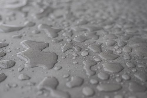 Close-Up Photo of Waters on Grey Surface