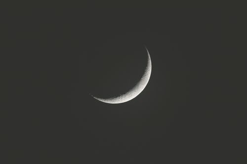 Free A serene crescent moon floating in the dark night sky, captured in India. Stock Photo