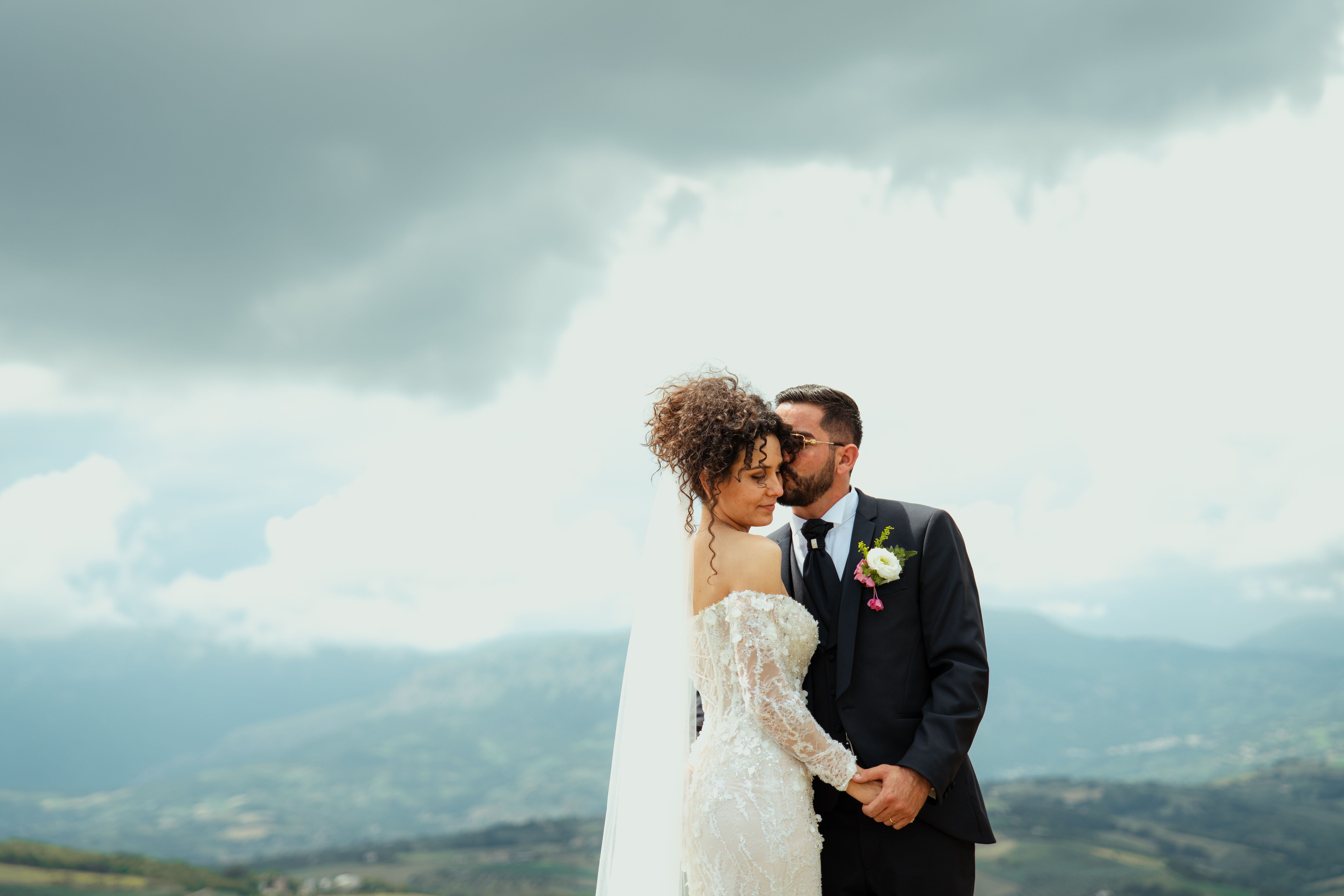 Elegant couple shares a moment on their wedding day in scenic Loreto Aprutino.