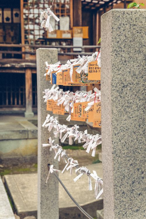Free Image of traditional Japanese wishing plaques and omikuji at a temple. Stock Photo
