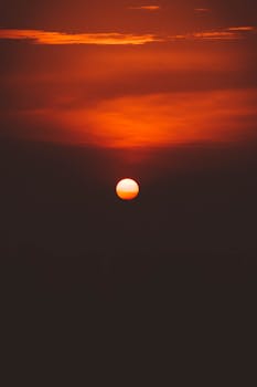 Captivating sunset with a dramatic red and orange sky, ideal for nature and travel visuals.