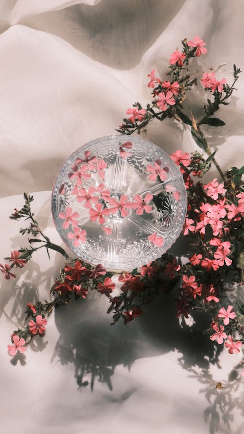 A glass ball with pink flowers on it