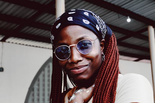 Portrait Photo of Smiling Woman in Sunglasses and Bandana Posing