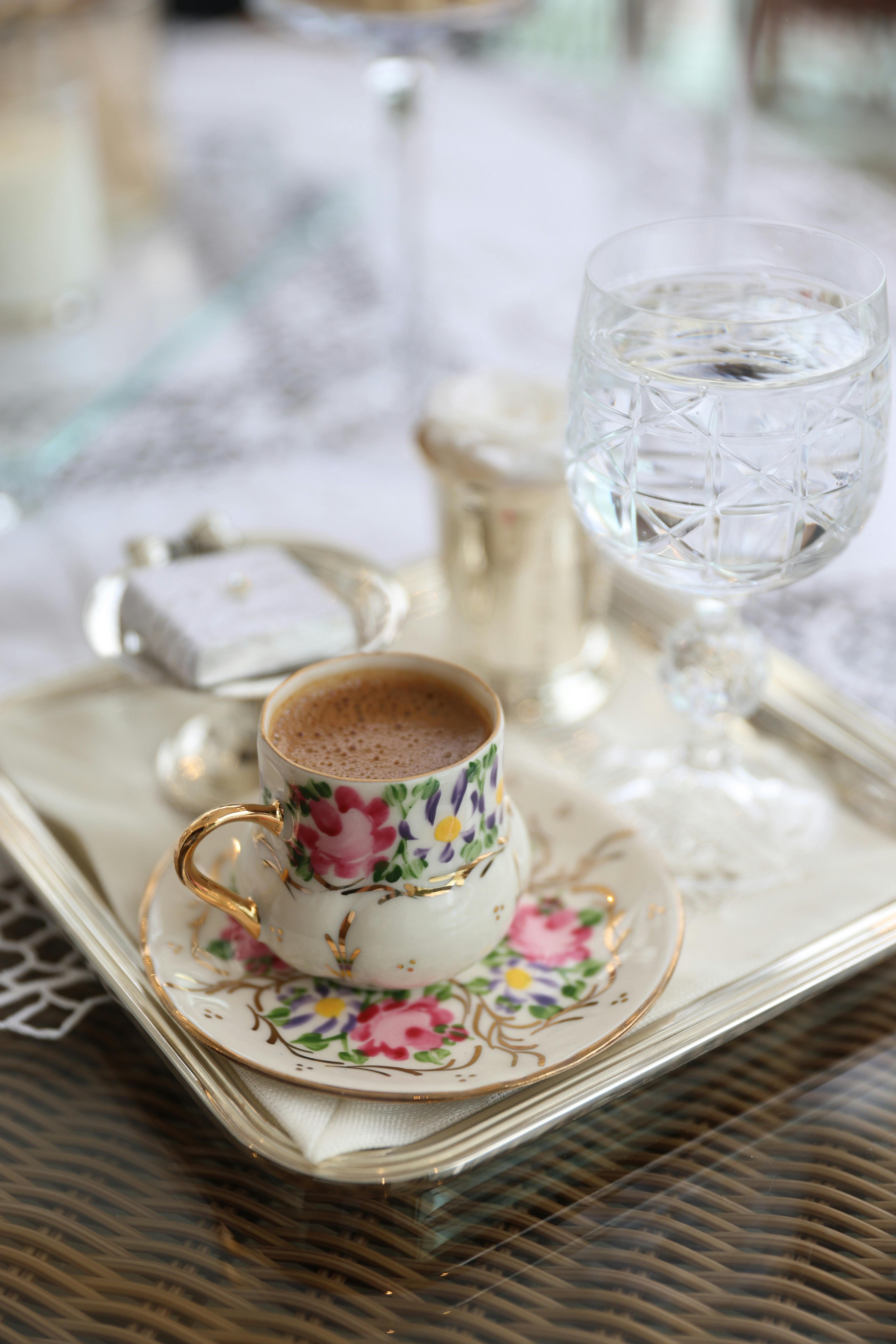 Aesthetic coffee scene with floral china and crystal glass.