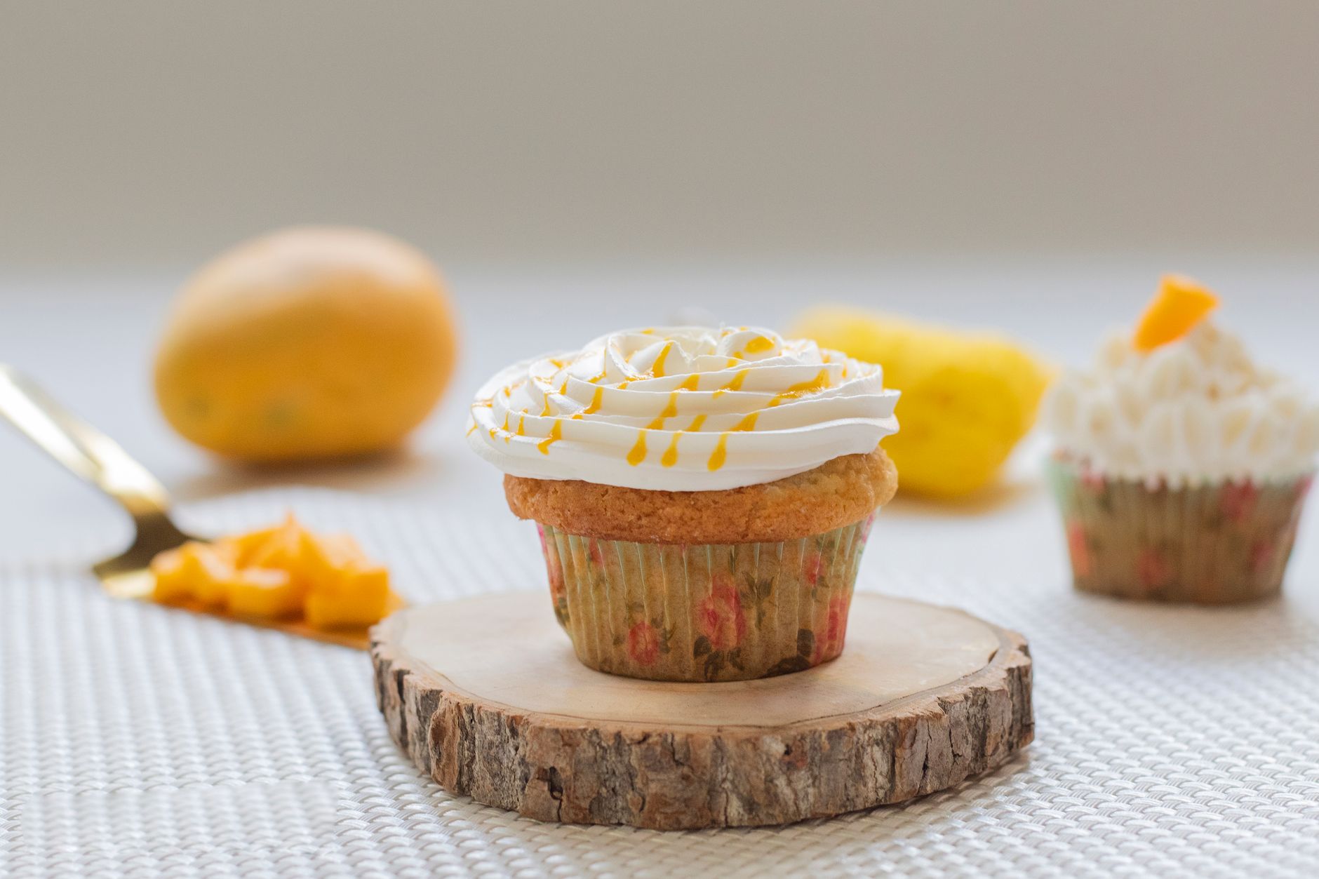 Beautiful mango cupcakes garnished with sliced almonds