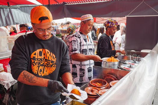 Urban street food market in São Paulo featuring vendors preparing Acarajé.