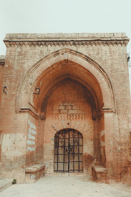Free Explore the intricate sandstone arch of Turkey's Ishak Pasha Palace, a significant architectural landmark. Stock Photo