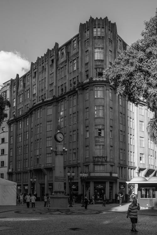 A black and white photo of a building with a clock tower