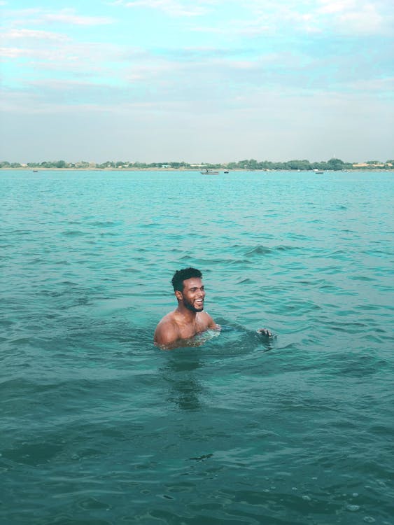 Free Man Swimming on the Ocean Stock Photo