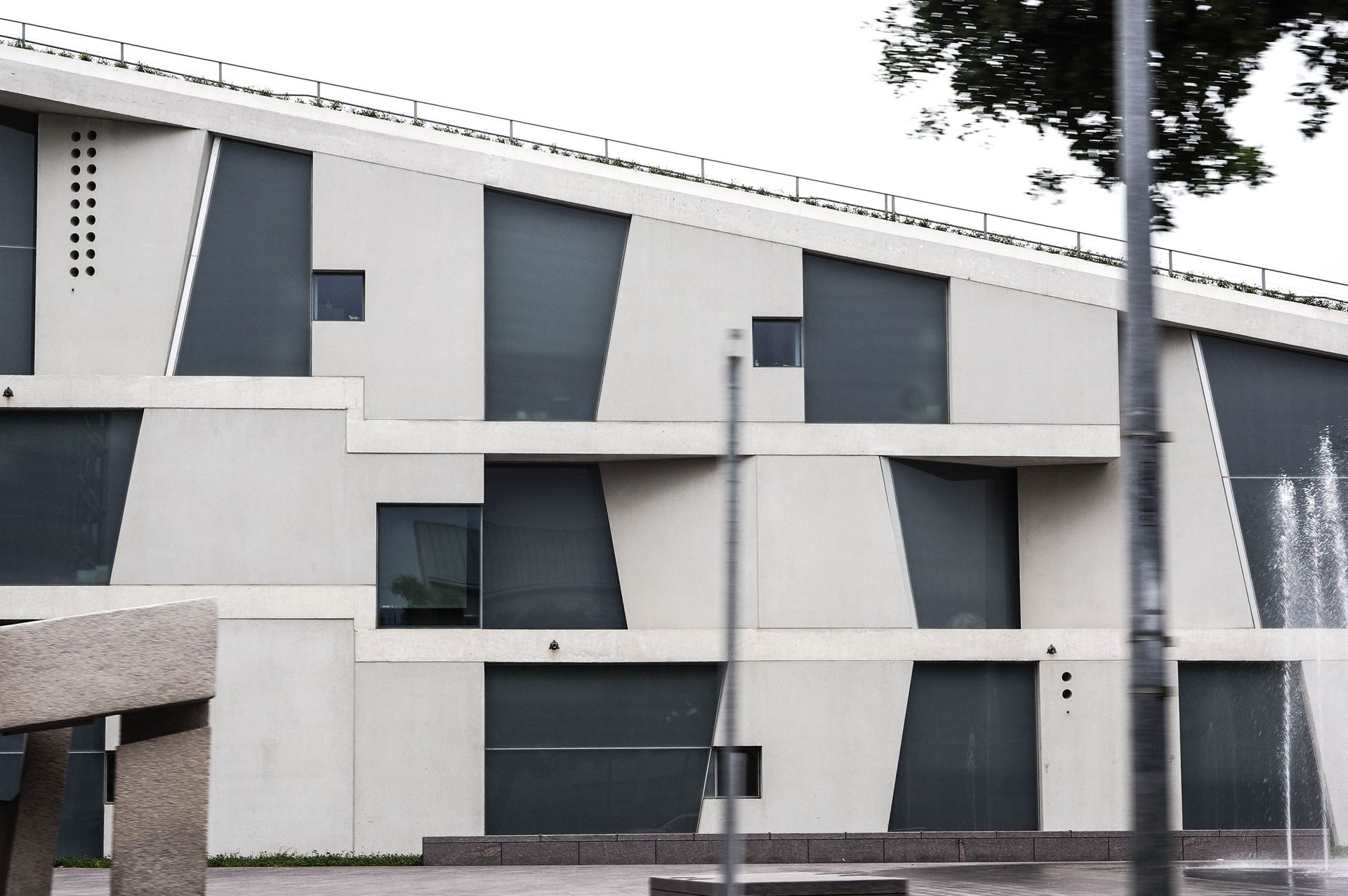 Contemporary building with geometric design and large glass panels, ideal for architectural studies.