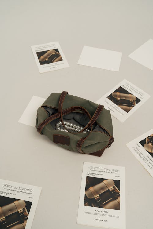A small green duffel bag with papers on it