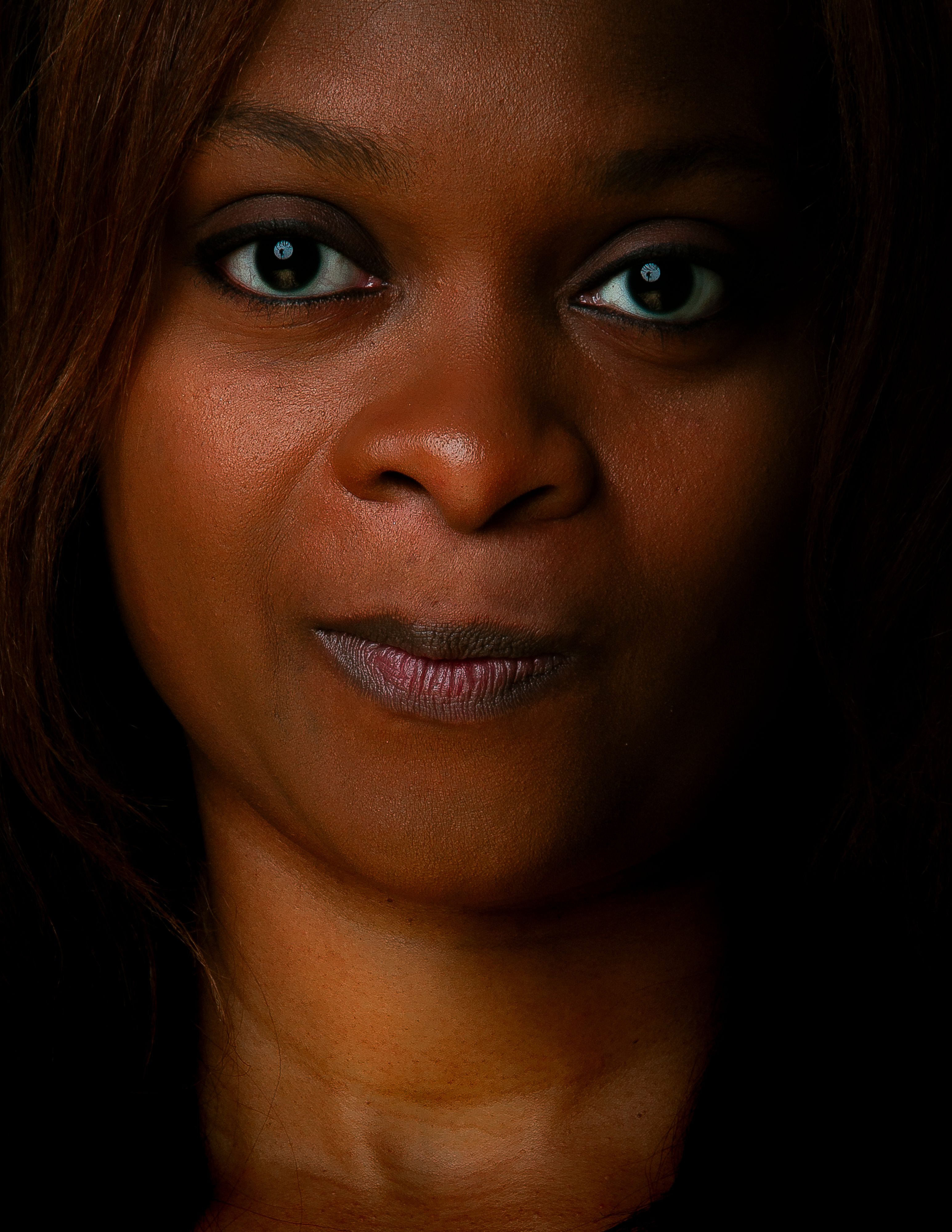 Captivating close-up portrait of a woman with expressive eyes, highlighting her natural beauty.