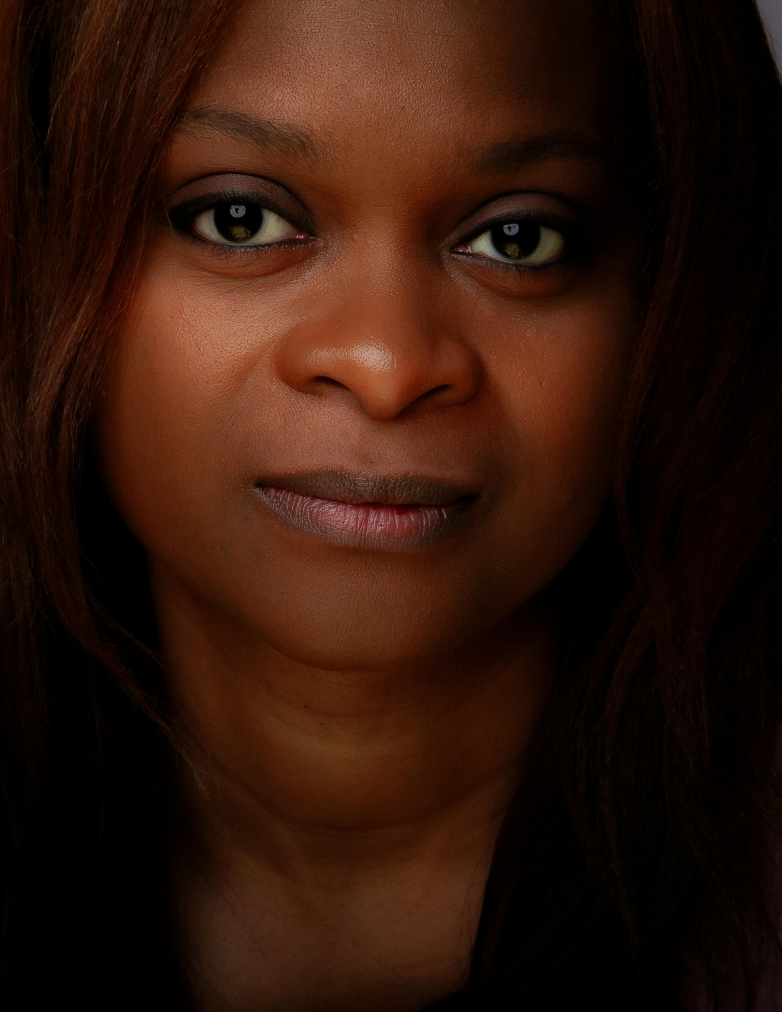 A compelling close-up portrait of a woman with an intense gaze, emphasizing natural beauty.