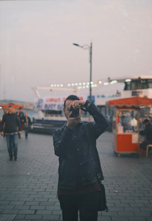 Man in Shirt Taking Pictures with Camera in Istanbul