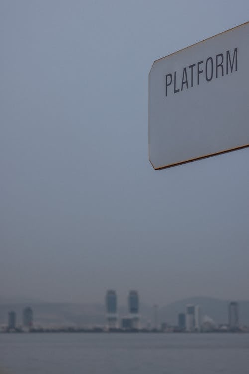 A sign that says platform in front of a city
